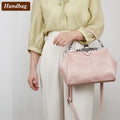 Women’s vintage retro hollow oil wax PU leather handbag with kiss lock clasp, crossbody design, and tote style.
