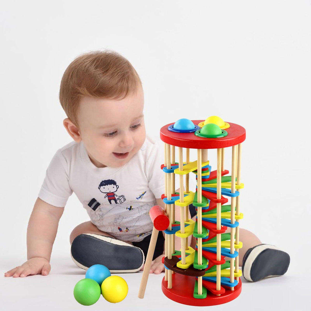 Wooden ball drop toy for kids with hammer and ramp, educational Montessori-style outdoor play equipment for children and babies.