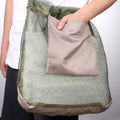 Green mushroom foraging bag by Everything Baby, practical and cute, ideal for collecting mushrooms during outdoor foraging trips.