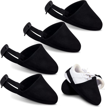 Two black bowling shoe covers from Everything Baby, designed for boys, used as protective sliders for bowling shoes.
