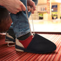 Pair of black bowling shoe covers from Everything Baby, designed to protect and slide over boys' shoes for bowling activities.
