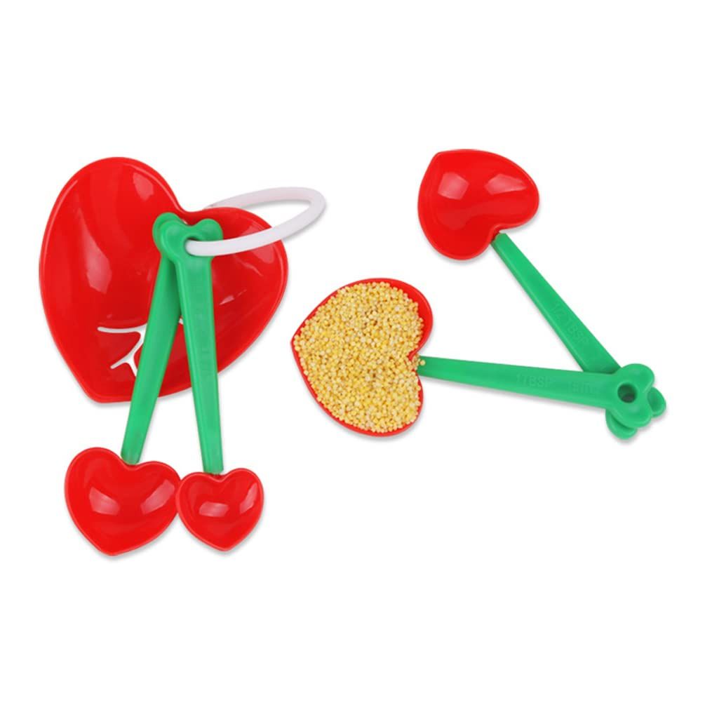 Five heart-shaped plastic measuring spoons set with egg separator and scoop for home kitchen baking and cooking.
