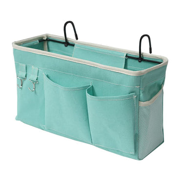 Green bedside hanging storage bag for kids, organizer for glasses, books, phones, and keys, fits dorm bed rails, by Everything Baby.