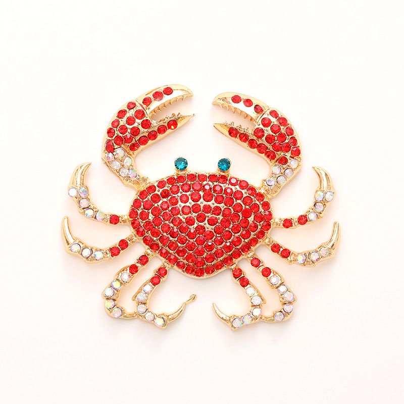 Set of four gold-plated rhinestone crab brooches with shiny crystals, perfect as marine-themed fashion accessories for women and girls.