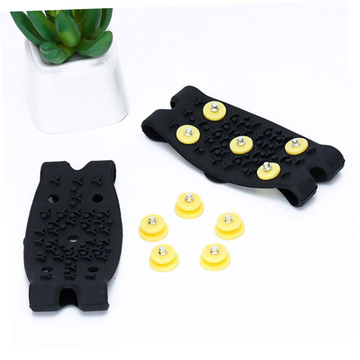 Two pairs of Everything Baby non-slip shoe covers with ice grippers for boys' shoes, designed for winter walking on ice and snow.