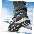 Two pairs of Everything Baby non-slip shoe covers with ice grips designed for boys' shoes, ideal for walking on ice and snow.