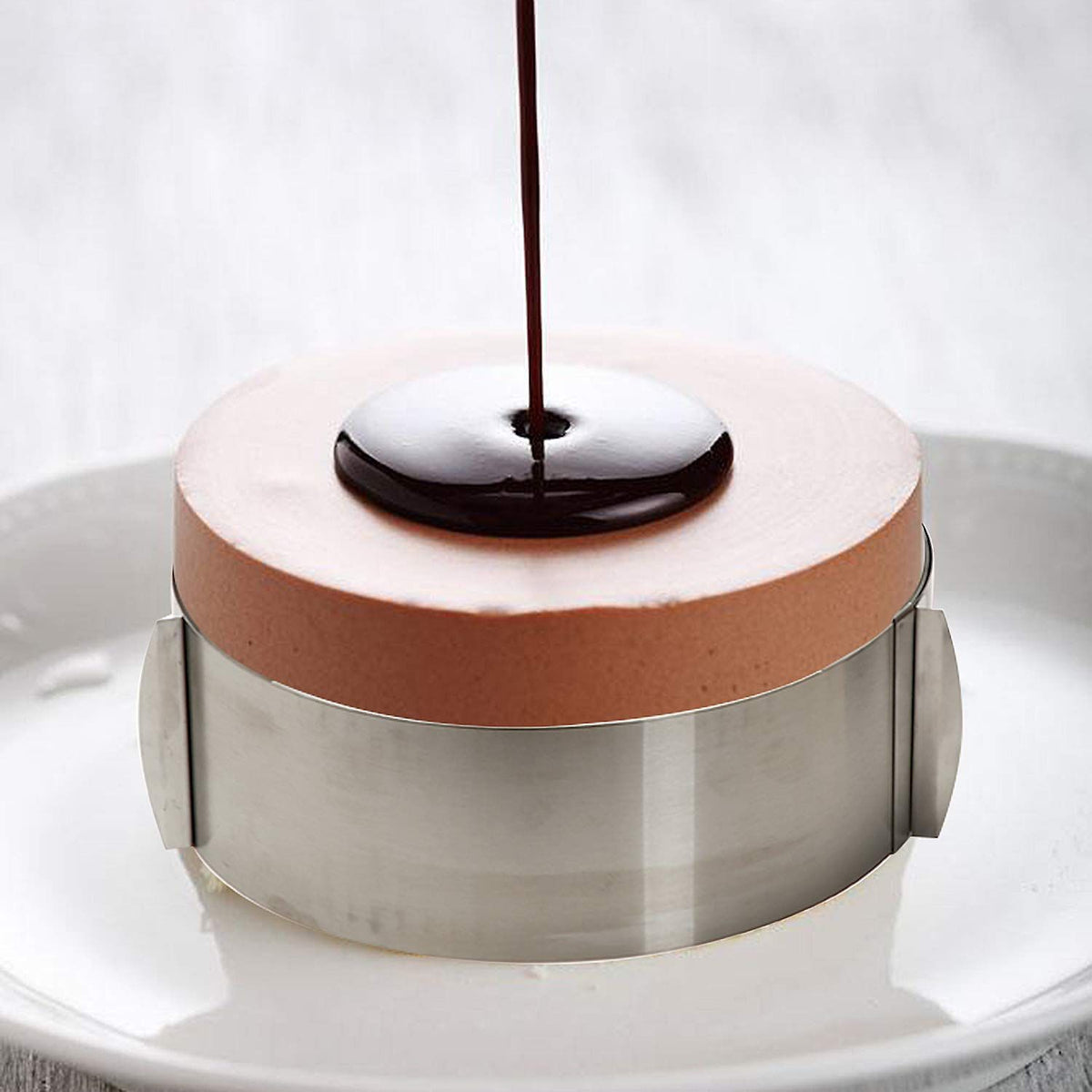 Adjustable stainless steel cake mold ring with sliding design, ideal for baking and cake decorating, by Everything Baby.