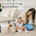 Portable corduroy nursery diaper storage basket with handle and adjustable dividers, ideal for baby supplies and organization.