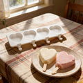 White silicone ice cream molds for DIY frozen desserts, 4-piece set, suitable for kids' pretend play and creative dessert making.