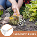 Durable metal clam rake with ergonomic wooden handle for outdoor shell digging, suitable for kids' outdoor play equipment.
