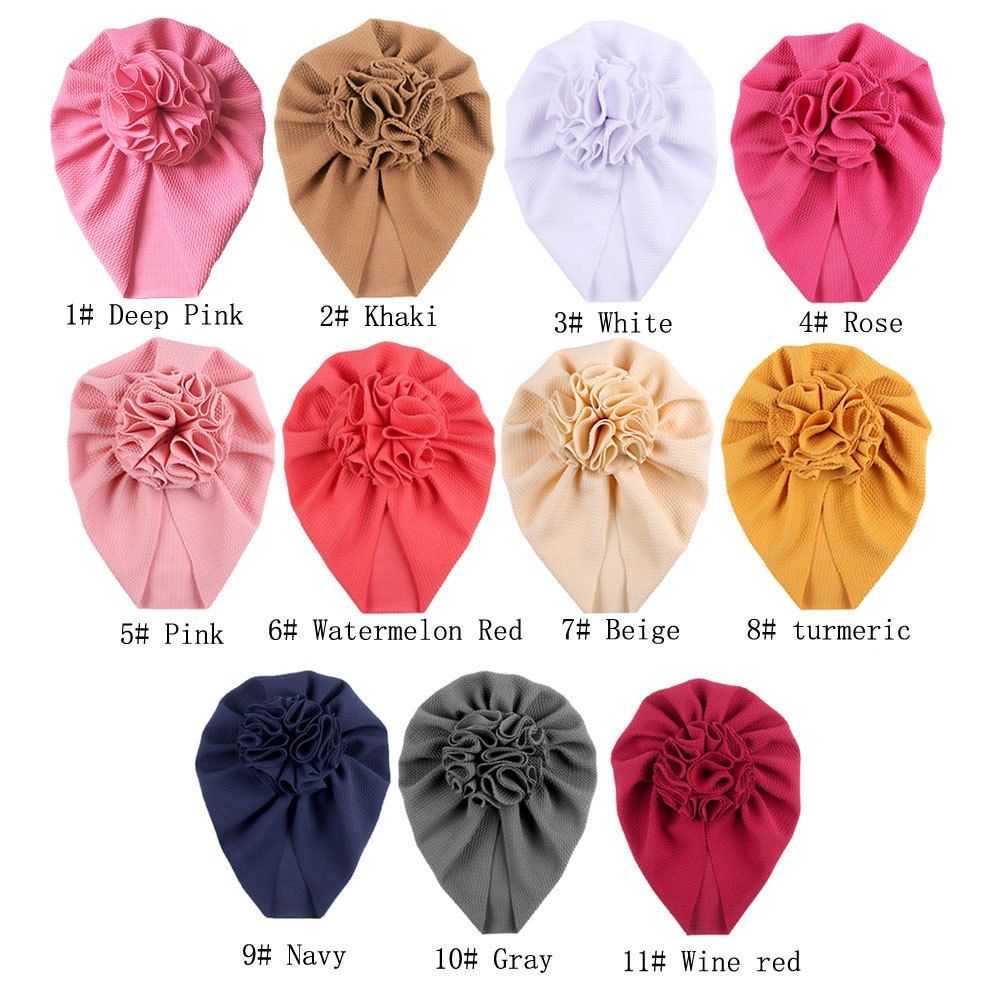 Baby girl hat with a large flower bow, soft beanie style, from Everything Baby, perfect for infants and toddlers.