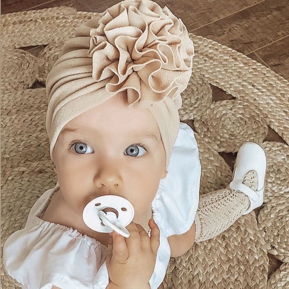 Baby girl hat with big flower bow, soft beanie cap for infants and toddlers, from Everything Baby.