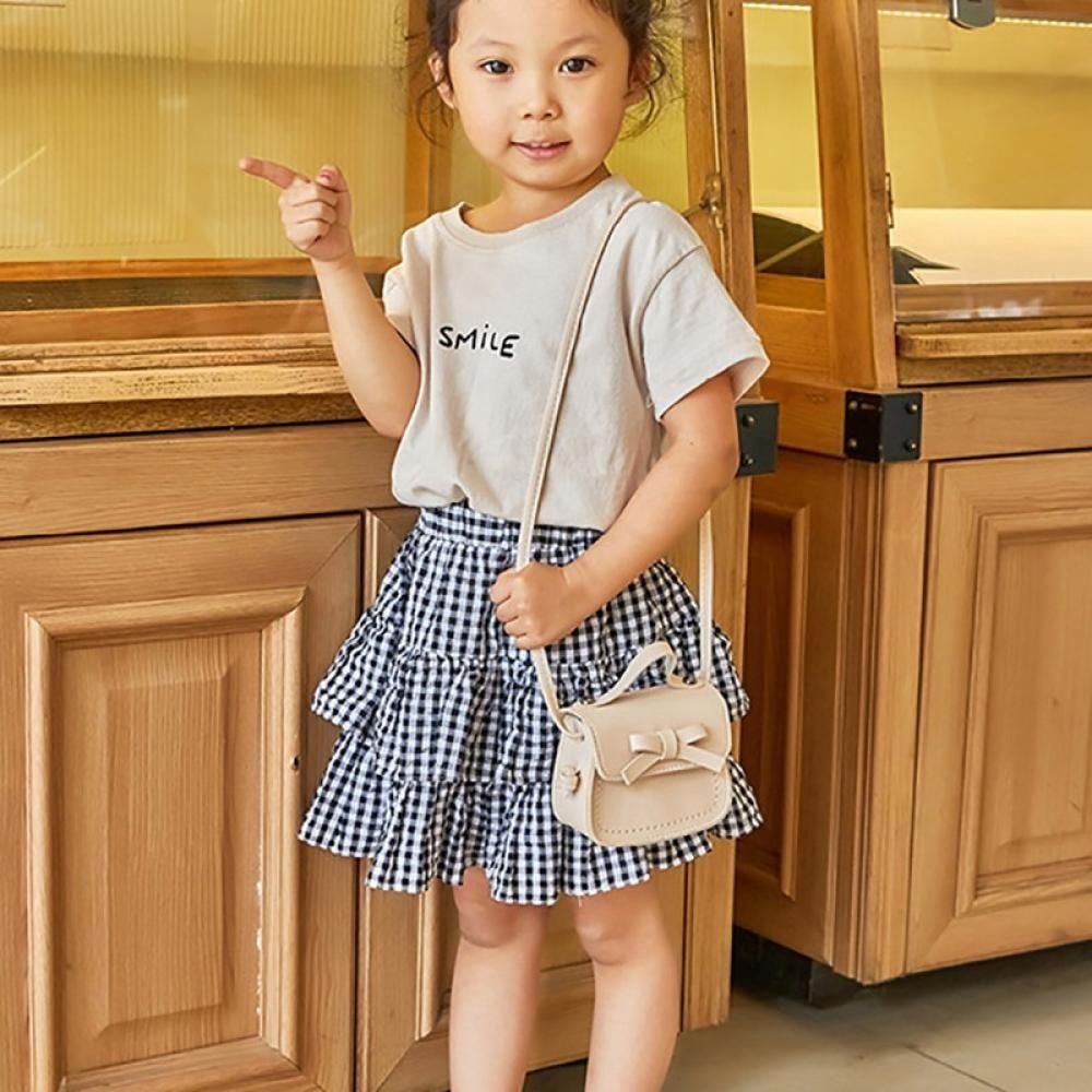 Cute kids' bow-shaped bag from Everything Baby, featuring a mini design with shoulder strap, ideal for little girls' toys and accessories.