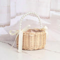 Handmade rattan wedding basket with handle and ribbon, suitable for outdoor play or decorative use, by Everything Baby.