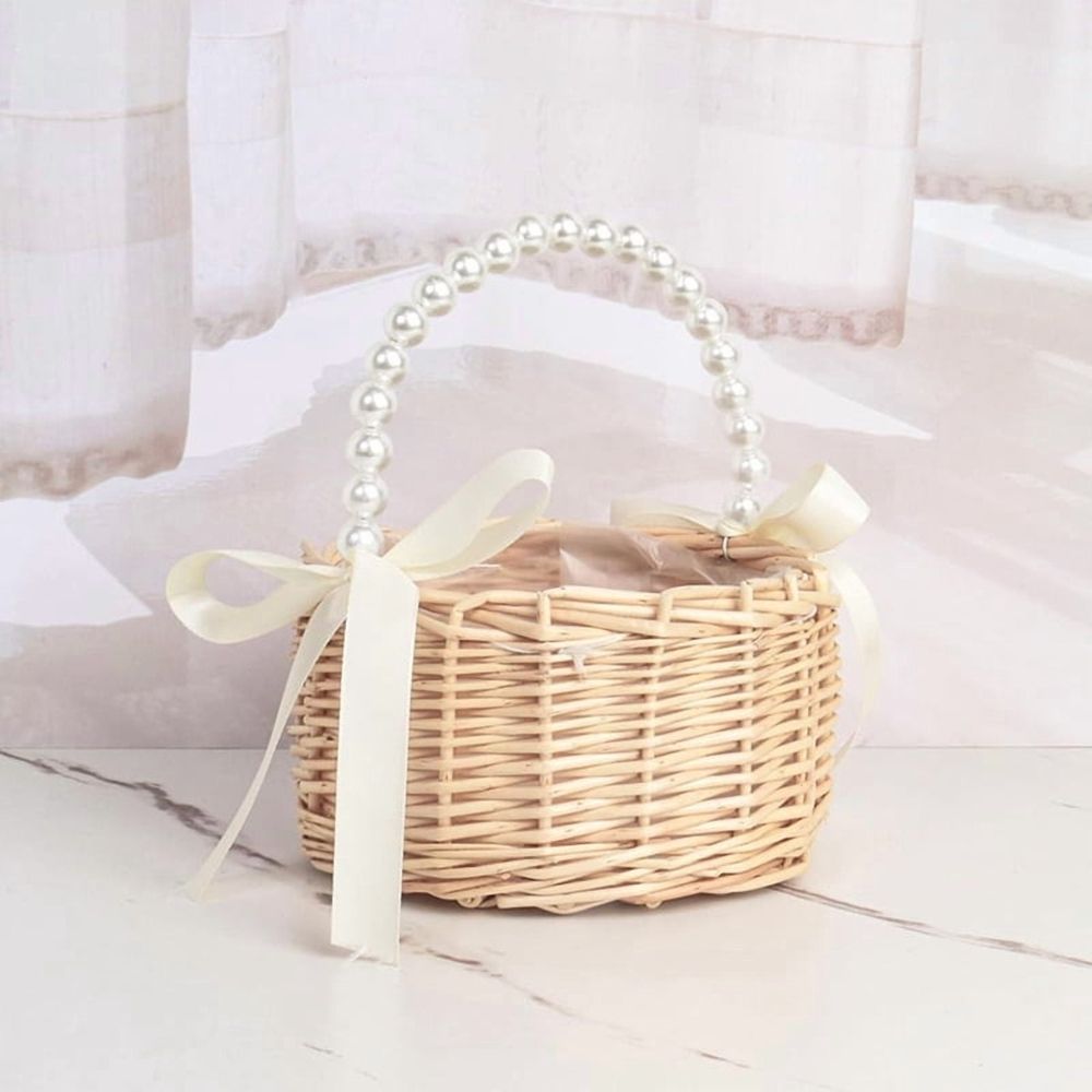 Handmade rattan wedding basket with handle and ribbon, suitable for outdoor play or decorative use, by Everything Baby.