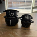 Mini witch cauldron set with 4 small cauldrons, candy buckets, and measuring cups for Halloween pretend play by Everything Baby.
