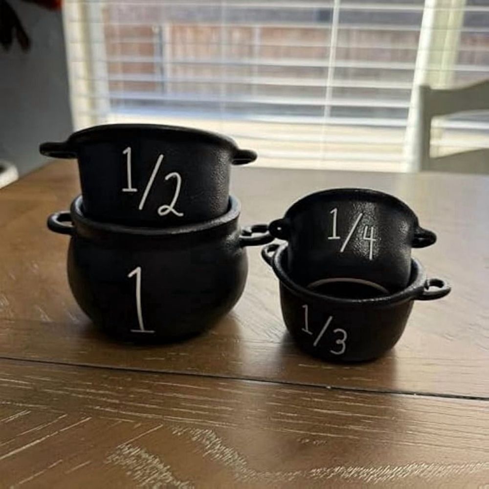 Mini witch cauldron set with 4 small cauldrons, candy buckets, and measuring cups for Halloween pretend play by Everything Baby.