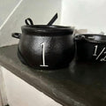Mini witch cauldron set with four small cauldrons and measuring cups for Halloween pretend play, perfect for kids' imaginative fun.