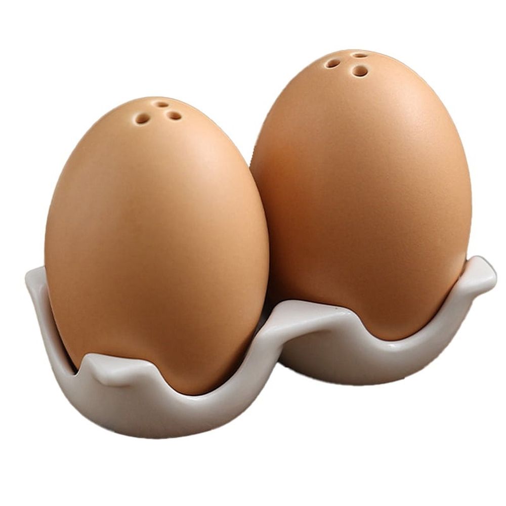 Mini brown egg-shaped ceramic salt and pepper shakers with carton design and holder, suitable for baby and kids feeding accessories.
