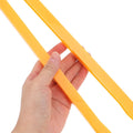 Orange plastic carpenter compass from Everything Baby, adjustable drawing tool for math education and kids' art and drawing activities.