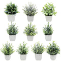 Artificial indoor plant with green leaves in a white modern planter, ideal for home or office decor.