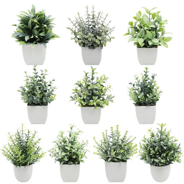Artificial indoor plant with green leaves in a white modern planter, ideal for home or office decor.