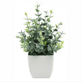Artificial indoor plant with green leaves in a modern white pot, ideal for desk or home decor, from Everything Baby.