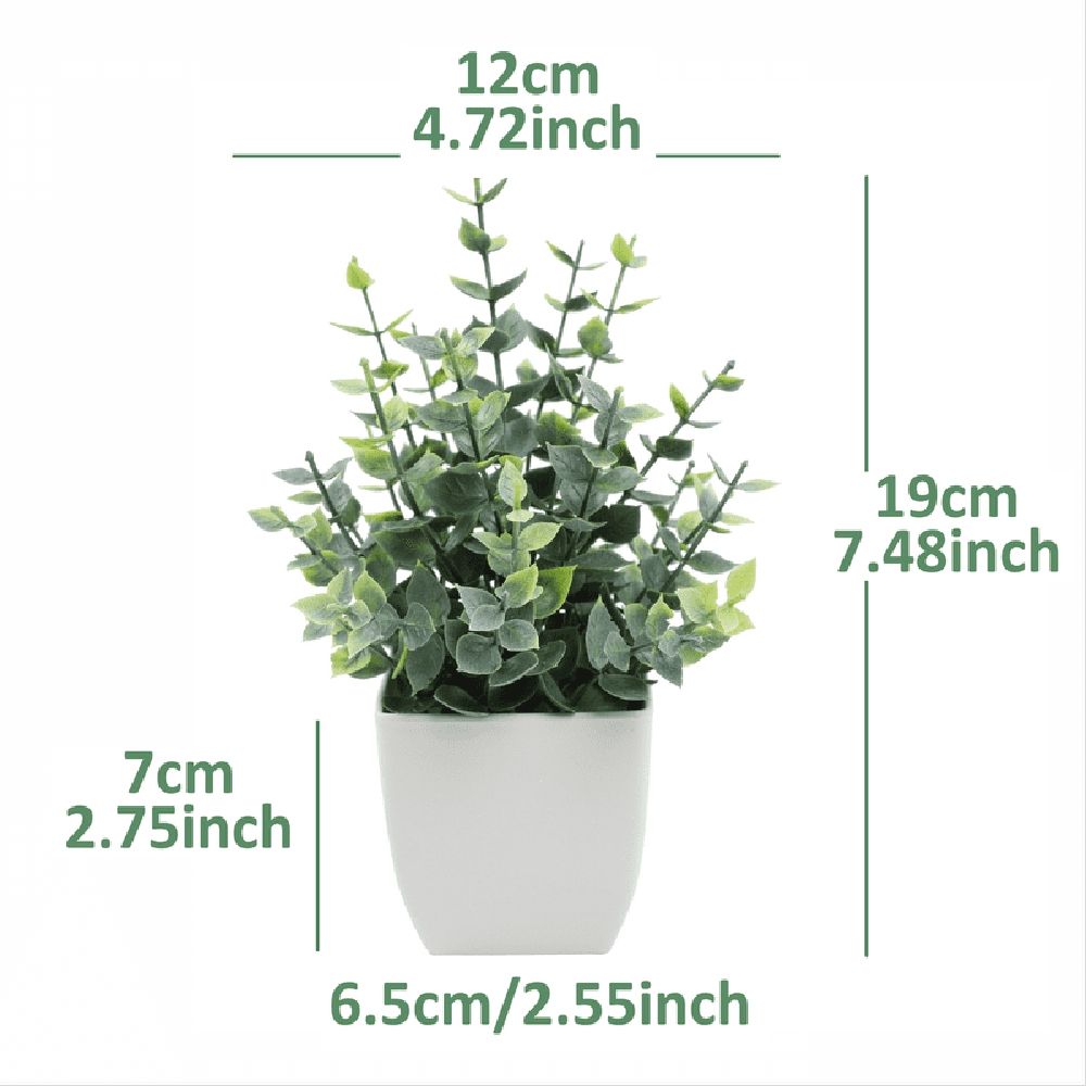 Artificial indoor plant with green leaves in a modern white pot, ideal for desk or home decoration.