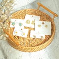 Small round rattan baby and kids bread basket with wooden handle, woven boho serving tray for pretend play and decorative use.