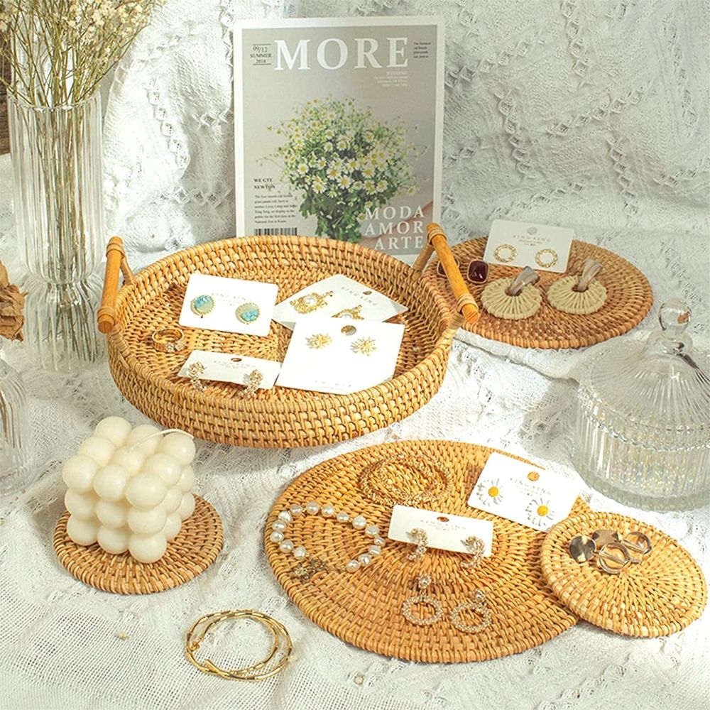 Small round rattan serving tray with wooden handle, handcrafted boho-style basket for coffee table or party decor.