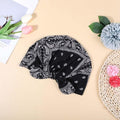 Baby girl wearing a pink beanie with a bow, turban-style headwear, suitable for sleep and casual wear by Everything Baby.