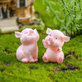 Eight cute pig figurines set, miniature pig toy figures for fairy garden decor, cake toppers, and holiday desk decorations.