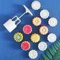 Pink Chinese flower moon cake press mold with 6 stamps, ideal for making decorative moon cakes and puff pastries for celebrations.