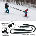 Black toddler ski training safety belt with nylon webbing and leash, designed for beginner snowboarders and kids' ski lessons.