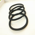 Set of 100 black mini seamless hair ties from Everything Baby, soft elastics ideal for toddlers and girls to hold ponytails.