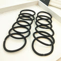 Set of 100 black mini seamless hair ties for girls and toddlers, soft elastics for ponytails, by Everything Baby.