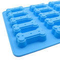 Two silicone molds shaped like small bones for making homemade dog and cat treats, perfect for baking and chocolate candies.