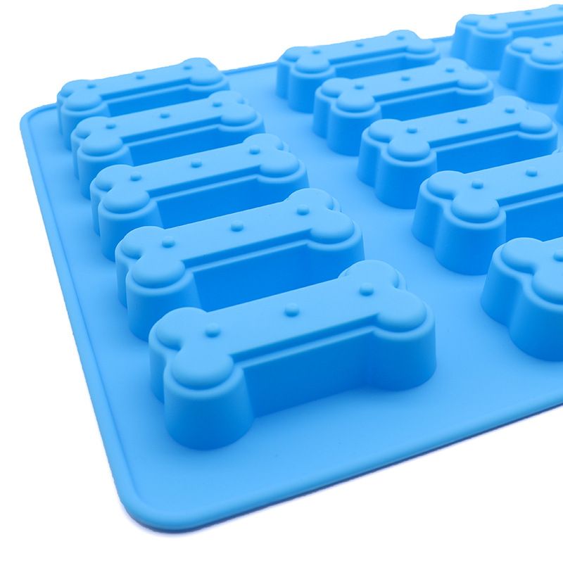 Two silicone molds shaped like small bones for making homemade dog and cat treats, perfect for baking and chocolate candies.