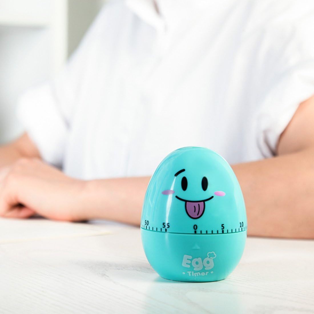Cute egg-shaped mechanical kitchen timer from Everything Baby, featuring a rotating alarm and cartoon egg design for cooking.