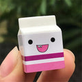 Six box-packed kawaii milk cookie erasers with cute design, ideal as creative school stationery for kids and children.