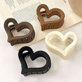 Set of four matte acrylic heart hair claw clips for women, non-slip design, perfect Valentine's Day accessories.