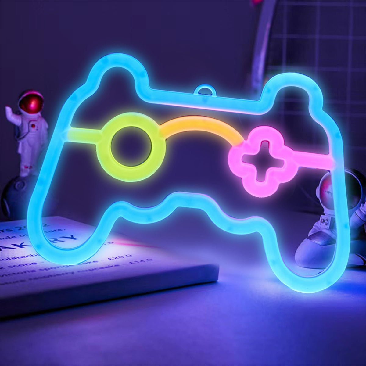 Bright neon sign shaped like a game controller, ideal for gamer room decor and teen gaming spaces, by Everything Baby.