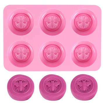 Pink round silicone mold with honeybee design for making homemade soaps, lotion bars, jello, bath bombs, or chocolates.
