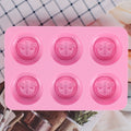 Pink round silicone mold with honeybee design for making soaps, lotion bars, jello, bath bombs, and chocolates.