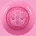 Pink round silicone honeybee mold for making soap, lotion bars, jello, bath bombs, and chocolates, ideal for DIY projects.