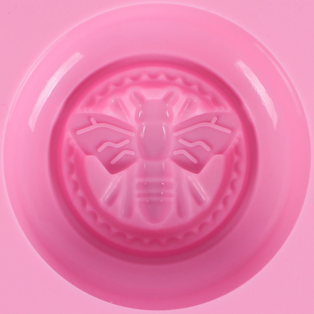 Pink round silicone honeybee mold for making soap, lotion bars, jello, bath bombs, and chocolates, ideal for DIY projects.
