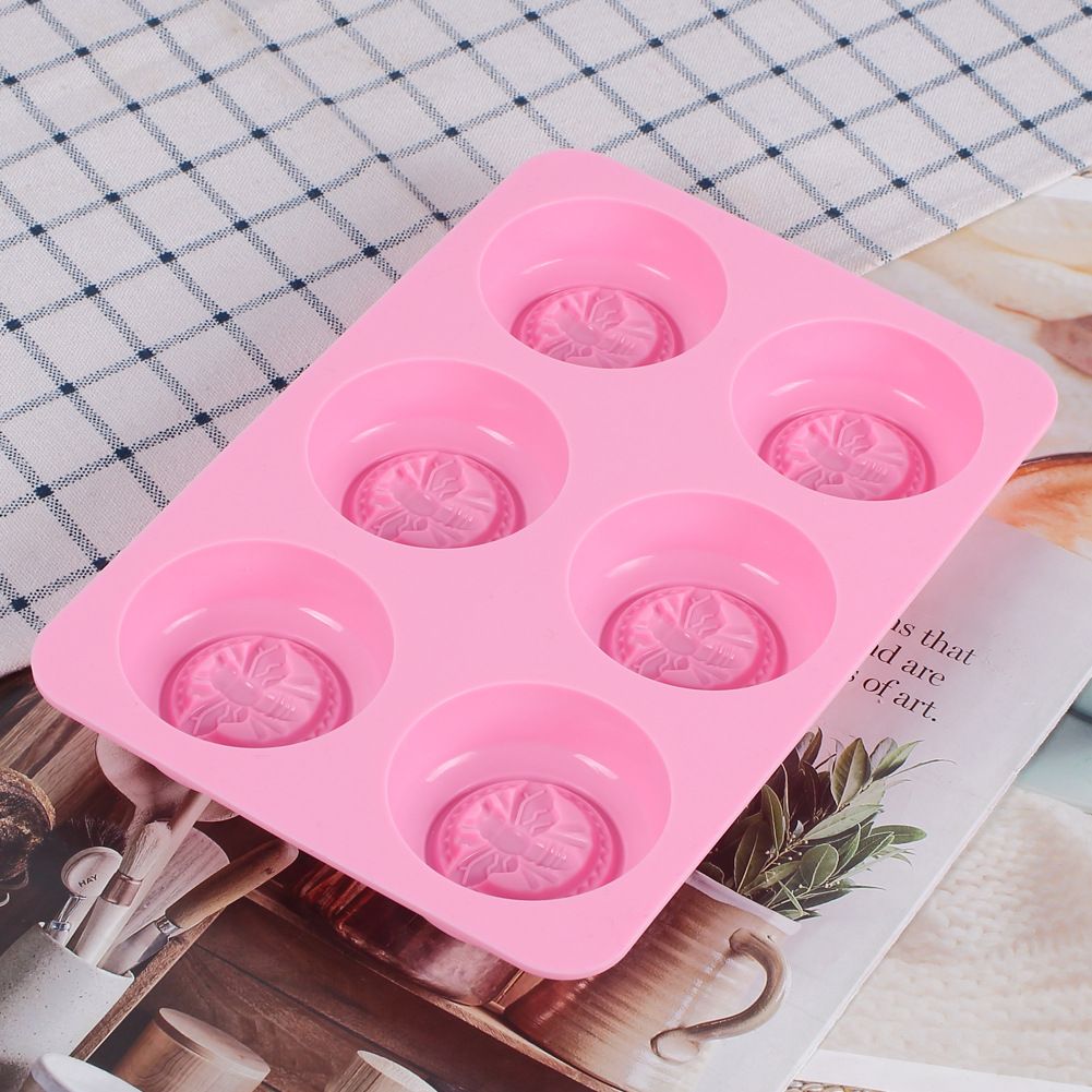 Pink round honeybee silicone mold for homemade soaps, bath bombs, chocolates, and lotion bars, ideal for DIY projects.