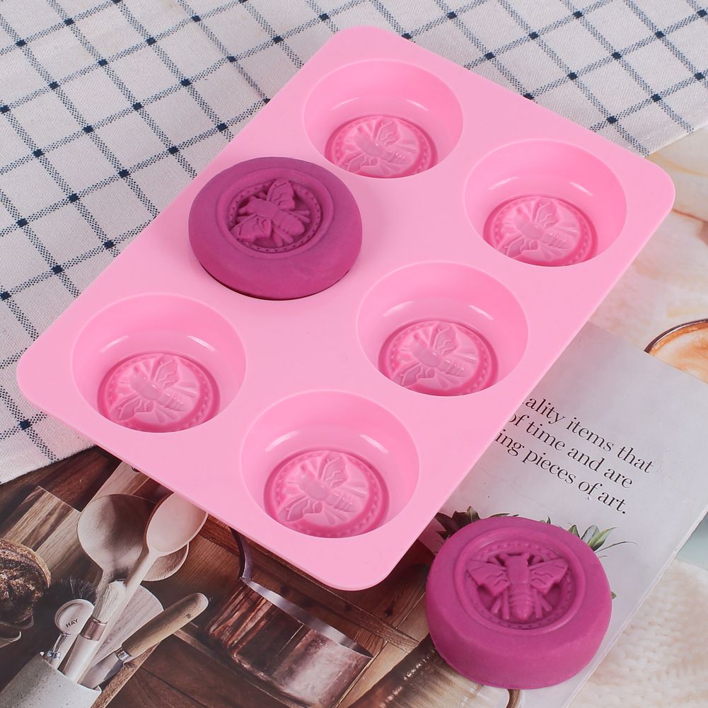 Pink round honeybee silicone mold for homemade soaps, lotion bars, jello, bath bombs, and chocolates, suitable for DIY baby and kids products.