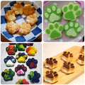 Colorful paw and bone-shaped bakeware set in pink, red, and purple for baking chocolates and candies, dishwasher safe.