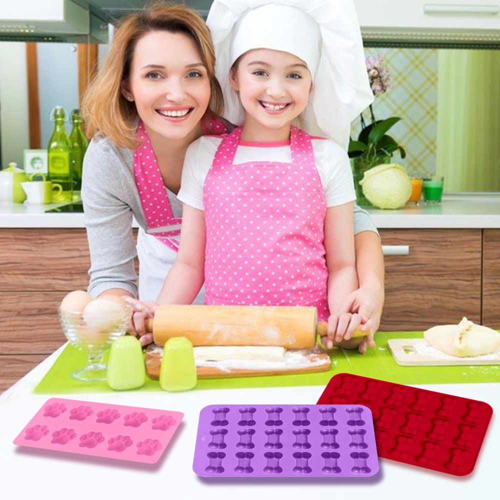 Pink, red, and purple paw and bone-shaped bakeware sets for chocolate and candy, dishwasher safe, from Everything Baby.